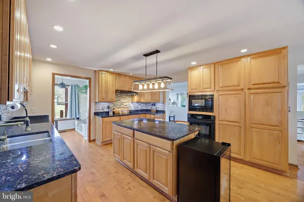 a view of a dining room with furniture and a chandelier