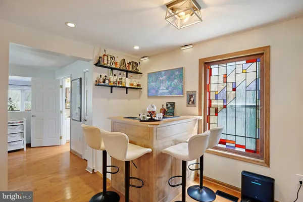 a dining room with furniture and a floor to ceiling window