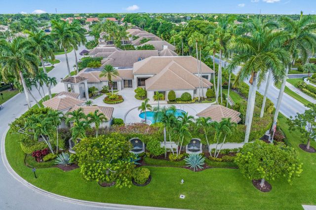 an aerial view of a house with outdoor space and a garden