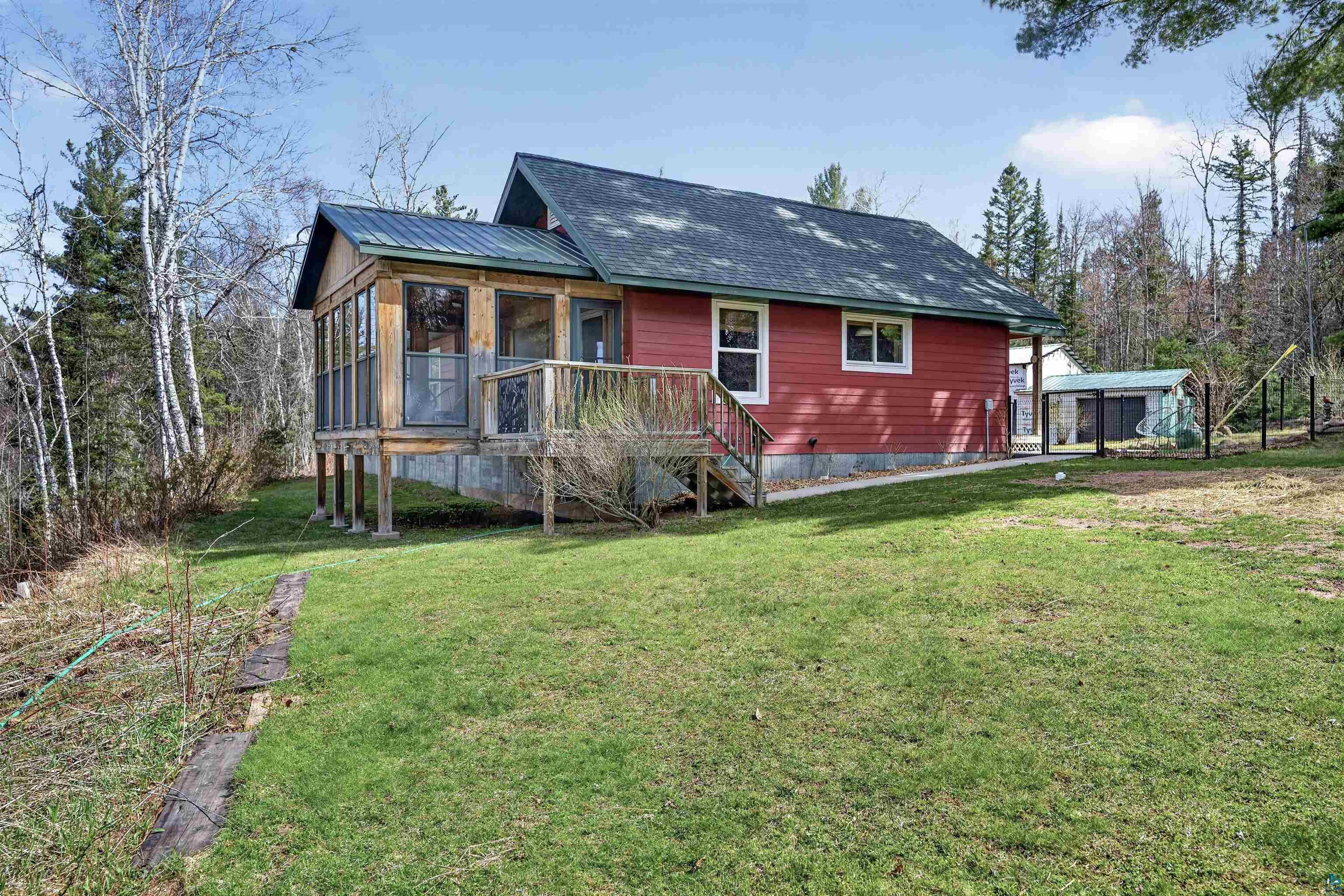 13885 Park Road Brule, WI 54820 - Photo 25 of 41 Red exterior home featuring a screened-in porch with a wood deck and stairs
