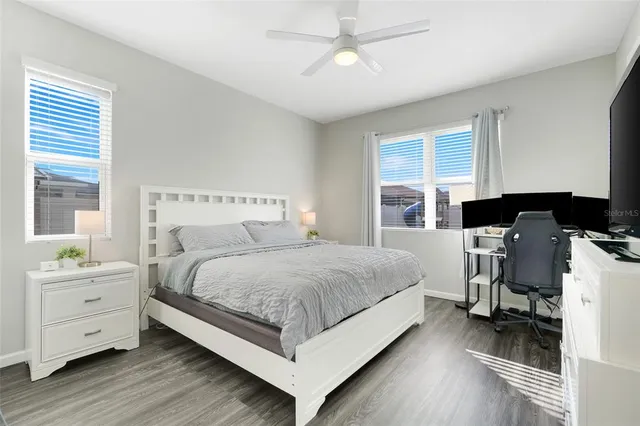 a bedroom with a bed and a desk