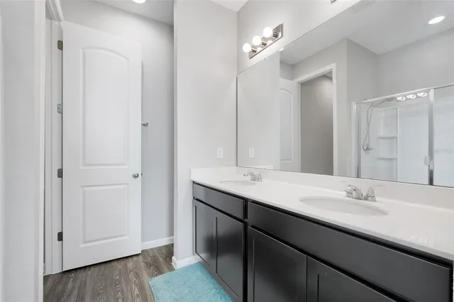 a bathroom with a double vanity sink and a mirror