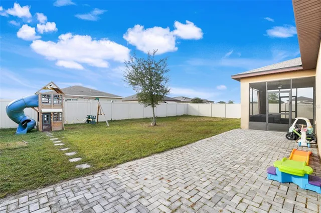a view of a house with a backyard