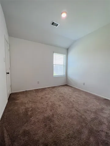 an empty room with a empty space and windows