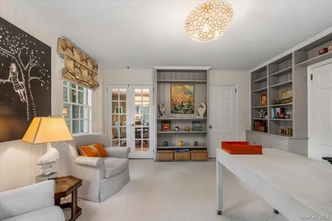 a living room with furniture and a book shelf