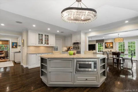 a view of a dining room with furniture wooden floor and chandelier