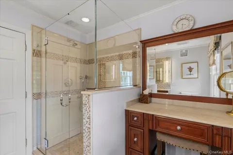 a bathroom with a shower sink and mirror