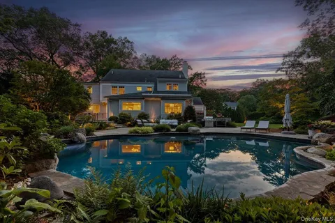 a view of a house with swimming pool and sitting area