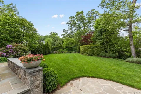 a garden with a bench in the garden