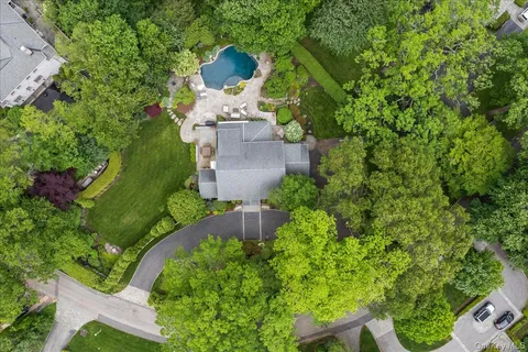 an aerial view of a house with swimming pool outdoor seating and entertaining space