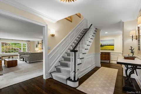 a view of entryway and hall with wooden floor