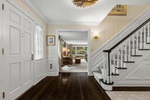 a view of entryway and hall with wooden floor