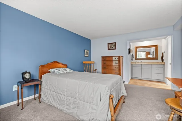 a bedroom with a bed and dresser