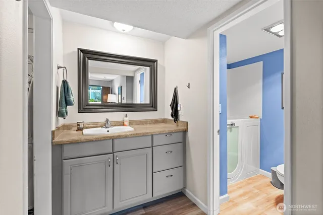 a bathroom with a double vanity sink and mirror