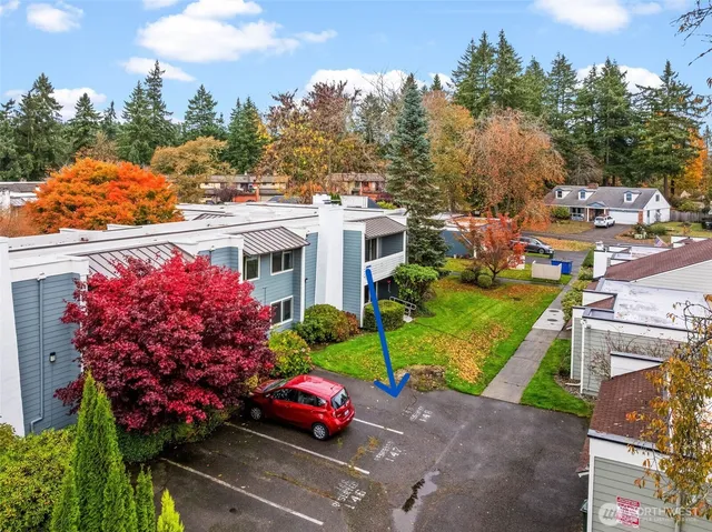 an aerial view of a house with a garden and outdoor seating