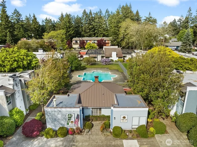 an aerial view of a house with swimming pool and garden