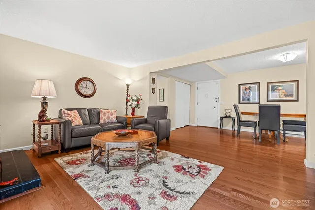 a living room with furniture and wooden floor