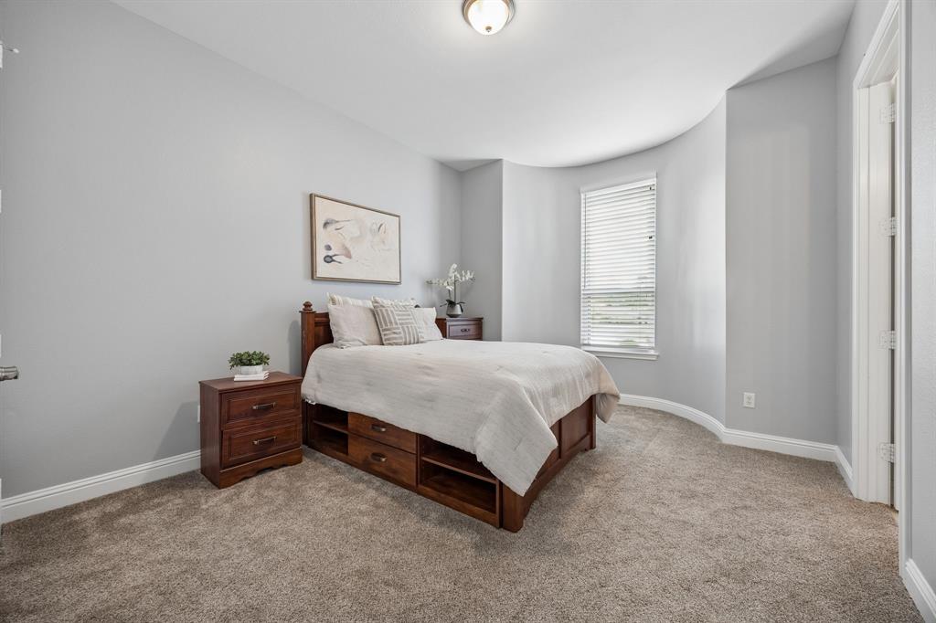 1011 Three Rivers Drive Prosper, TX 75078 - Photo 12 of 27 a bedroom with a bed and a window