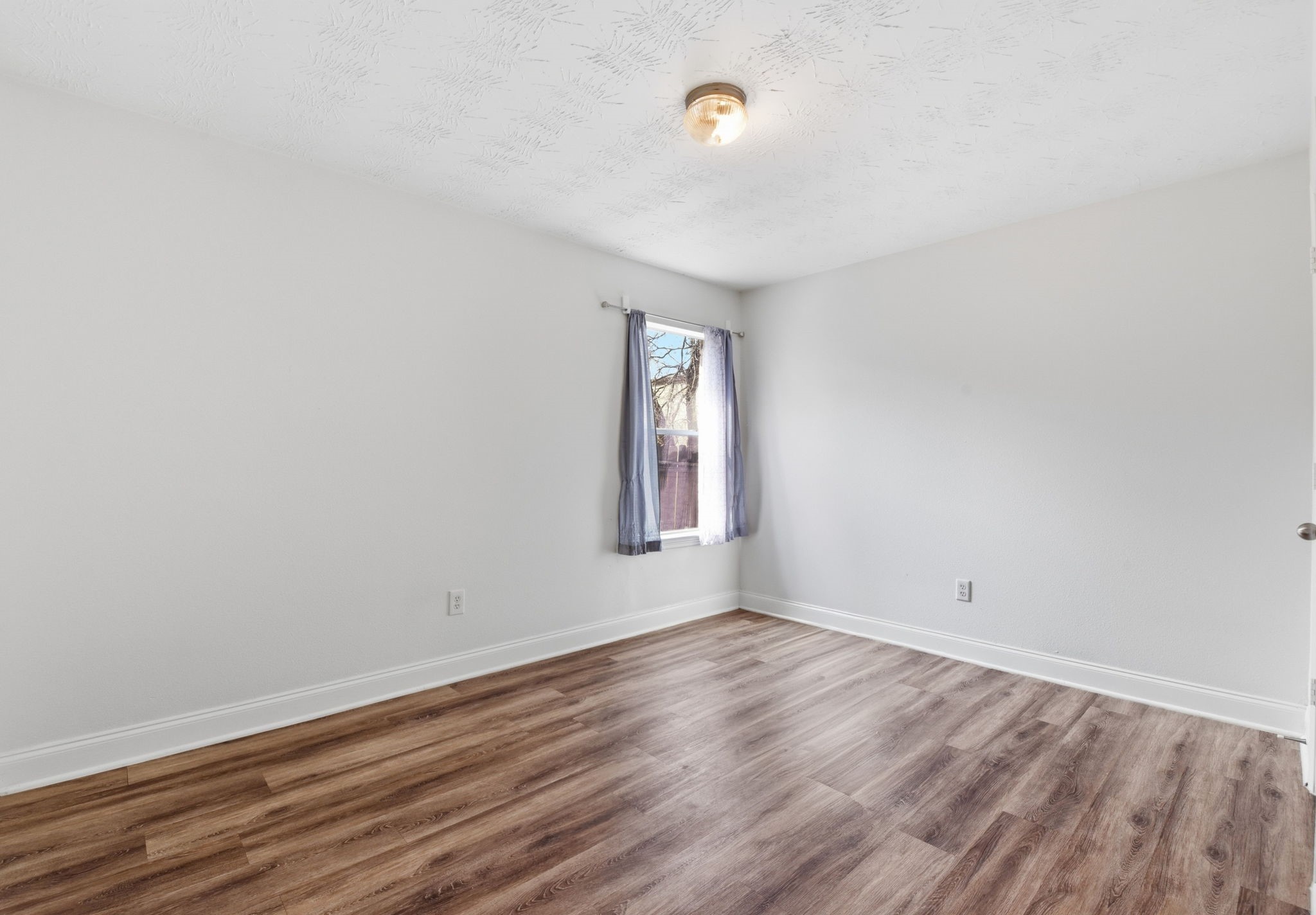 19013 Hammer Lane Porter, TX 77365 - Photo 17 of 35 an empty room with wooden floor and windows