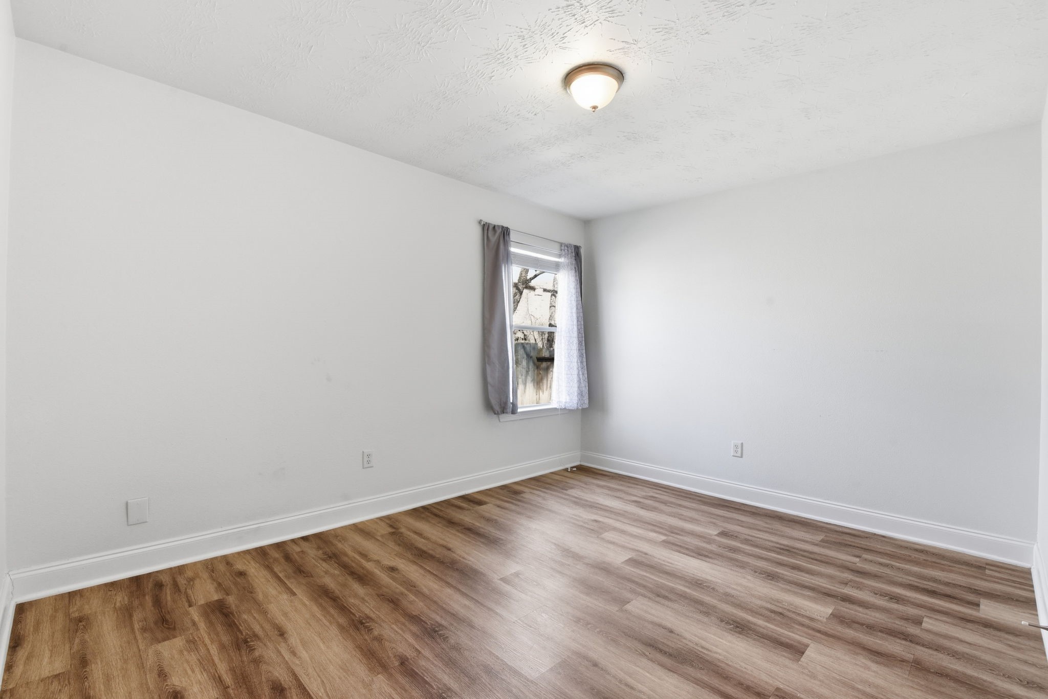 19013 Hammer Lane Porter, TX 77365 - Photo 19 of 35 an empty room with wooden floor and windows