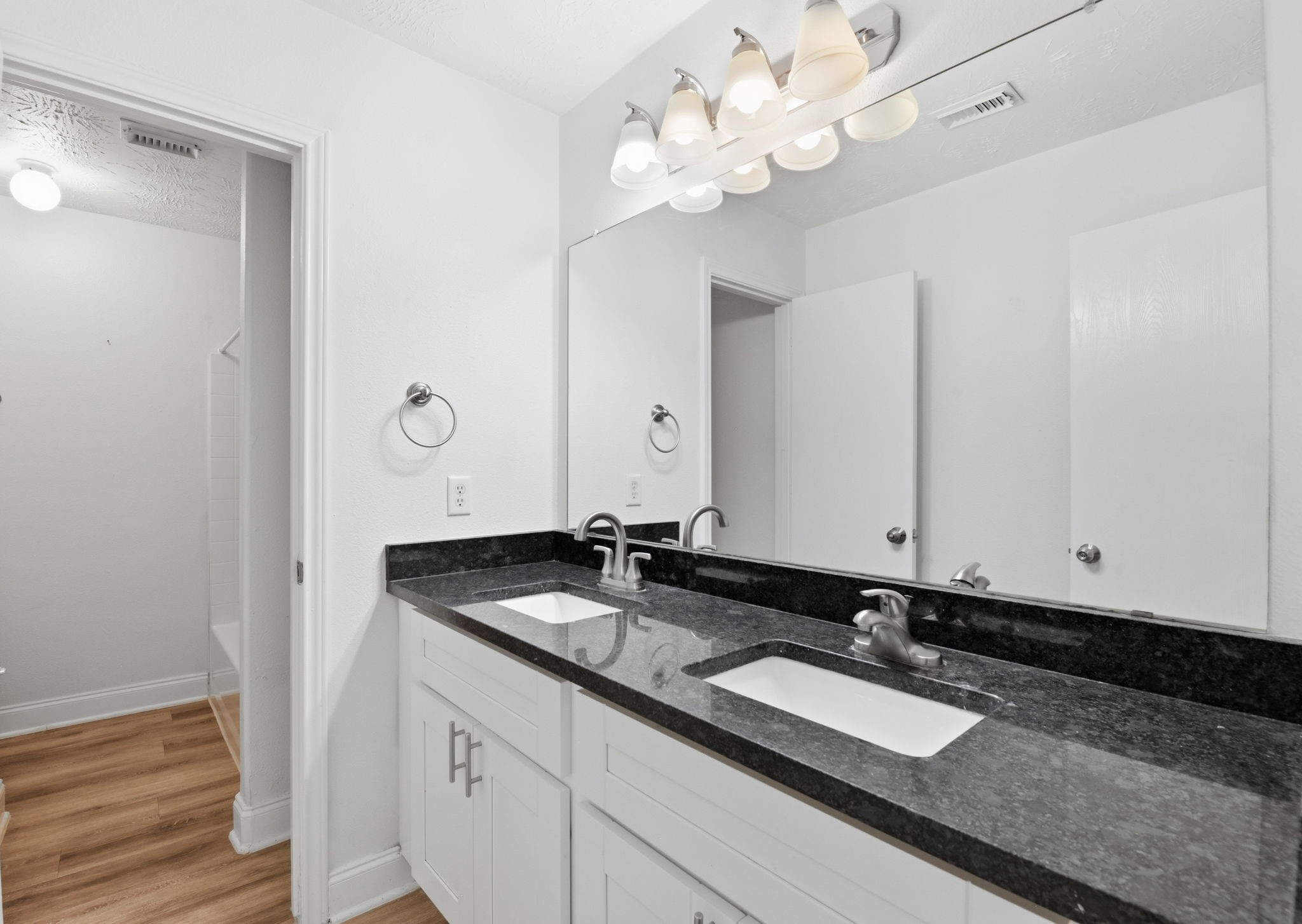 19013 Hammer Lane Porter, TX 77365 - Photo 21 of 35 a bathroom with a granite countertop double vanity sink and a mirror