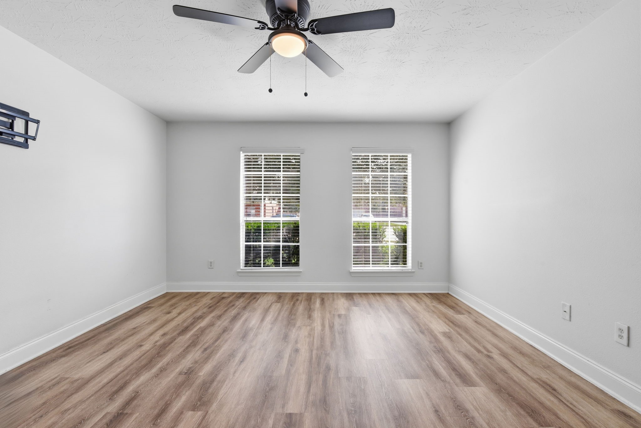 19013 Hammer Lane Porter, TX 77365 - Photo 24 of 35 an empty room with wooden floor chandelier fan and windows
