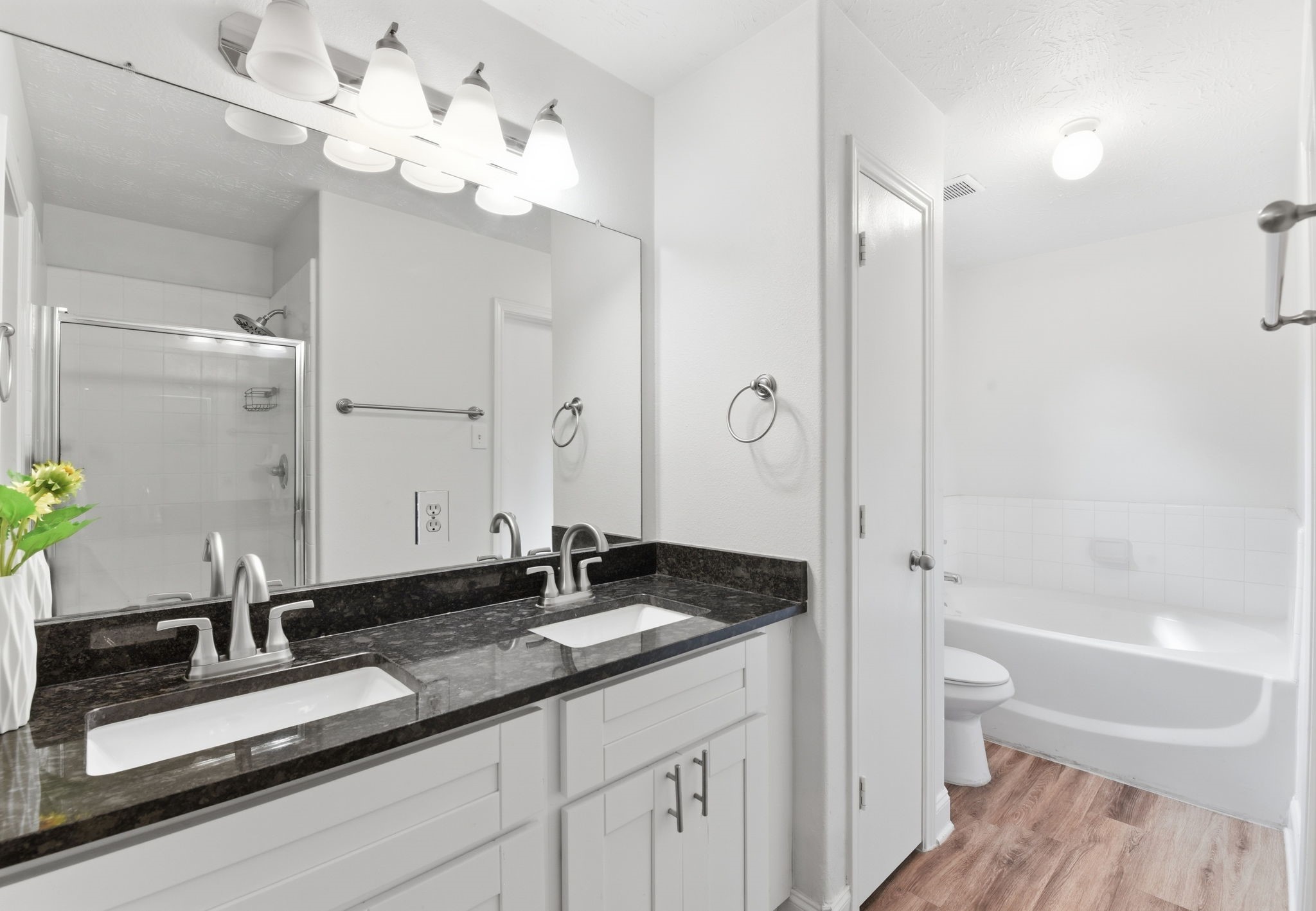 19013 Hammer Lane Porter, TX 77365 - Photo 26 of 35 a bathroom with a double vanity sink toilet and shower