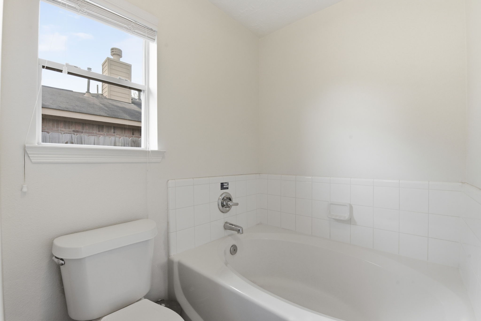 19013 Hammer Lane Porter, TX 77365 - Photo 28 of 35 a bathroom with a toilet and a bathtub