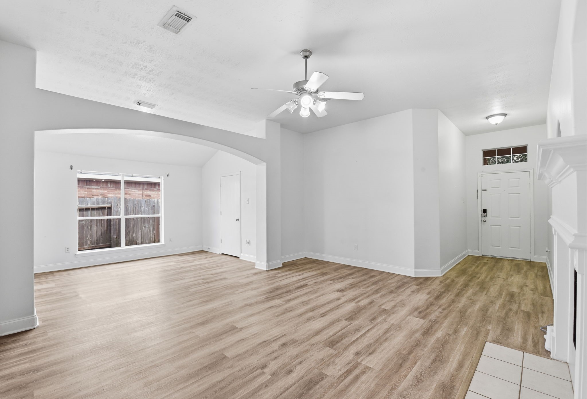 19013 Hammer Lane Porter, TX 77365 - Photo 8 of 35 an empty room with wooden floor ceiling fan and windows