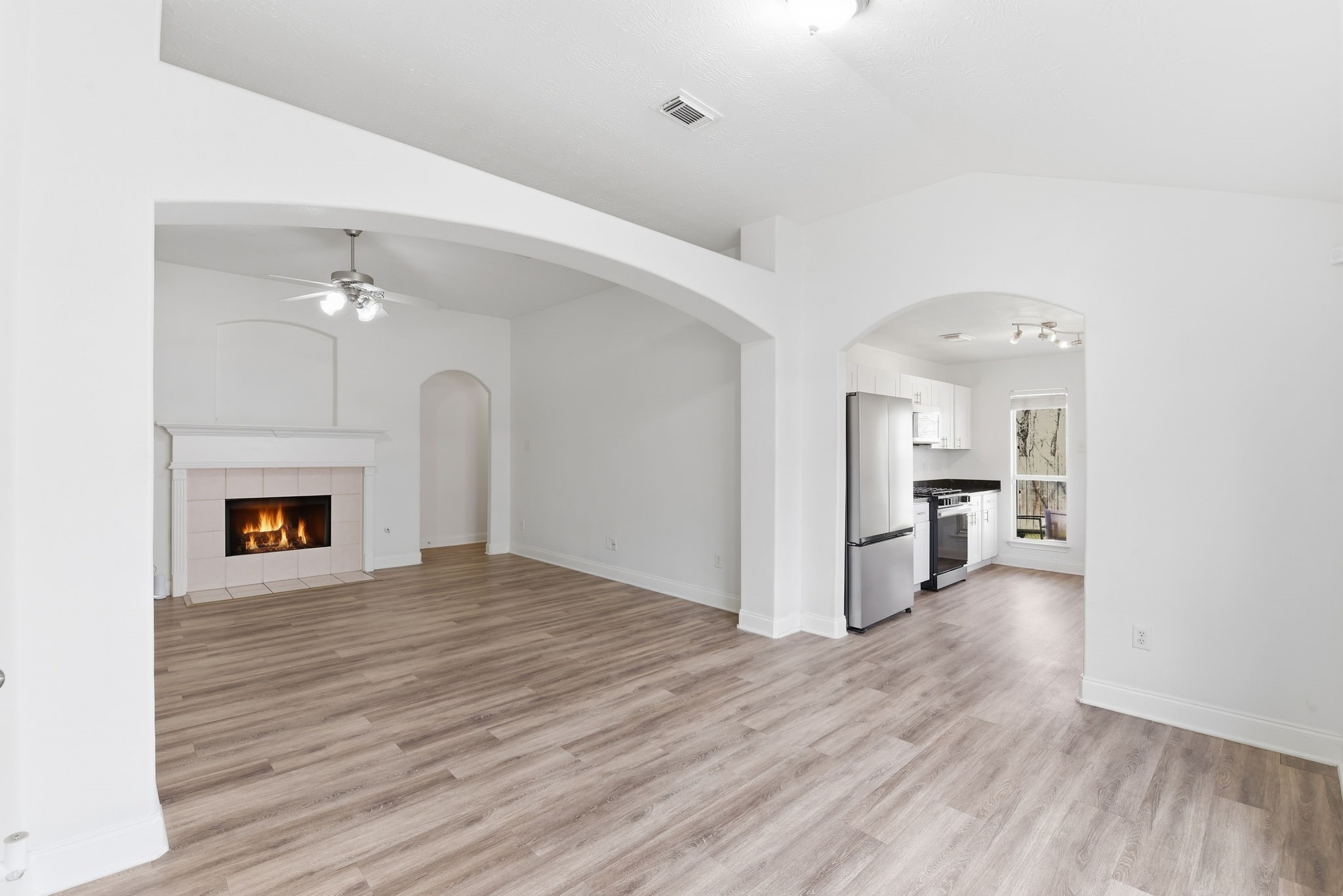 19013 Hammer Lane Porter, TX 77365 - Photo 10 of 35 a view of a livingroom with a fireplace and wooden floor