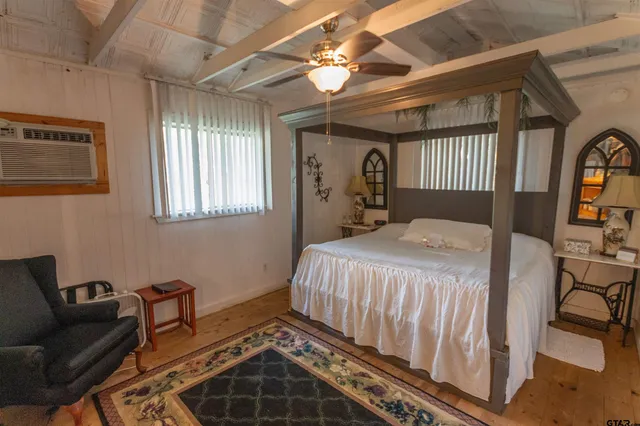 a bedroom with a bed couch and a window