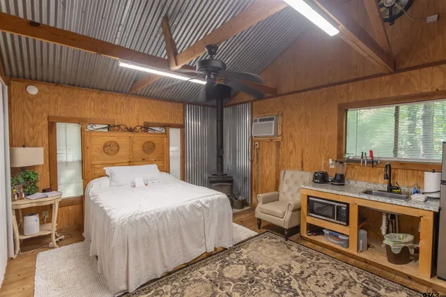 a bedroom with a bed next to a large window with the outer view