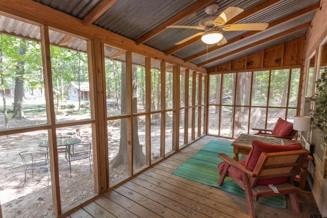a living room with furniture and a floor to ceiling window
