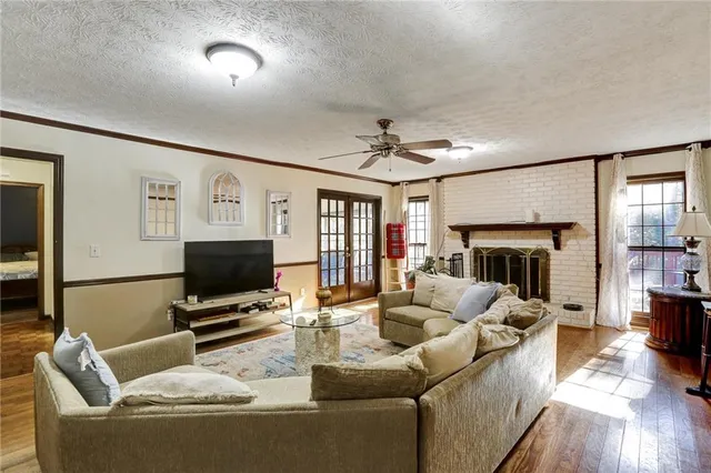 a bathroom with a granite countertop sink a toilet and a mirror