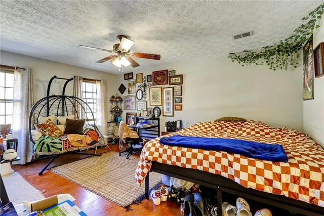 a front view of house with yard and trees in the background