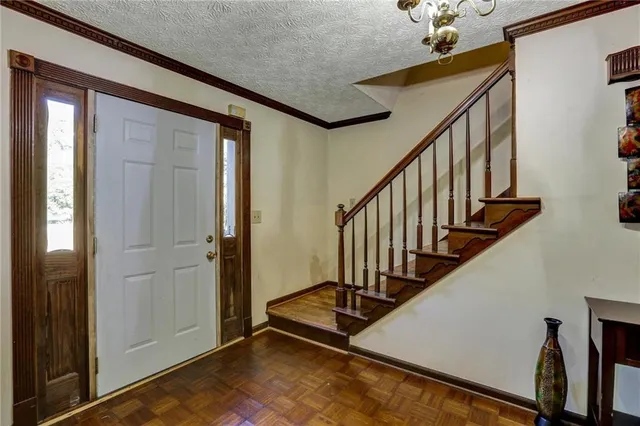 a large kitchen with stainless steel appliances granite countertop a large counter top a stove and a refrigerator