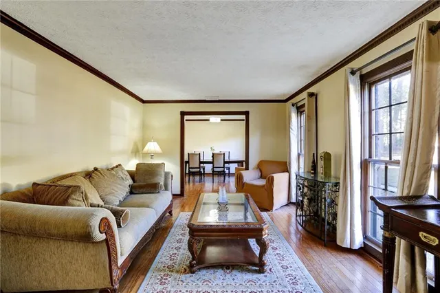 a kitchen with stainless steel appliances granite countertop a sink a stove and a wooden floors