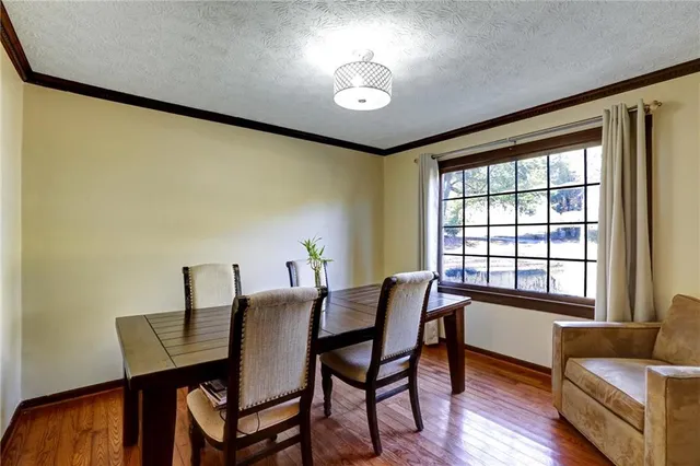a bathroom with a sink vanity granite tub and shower curtain