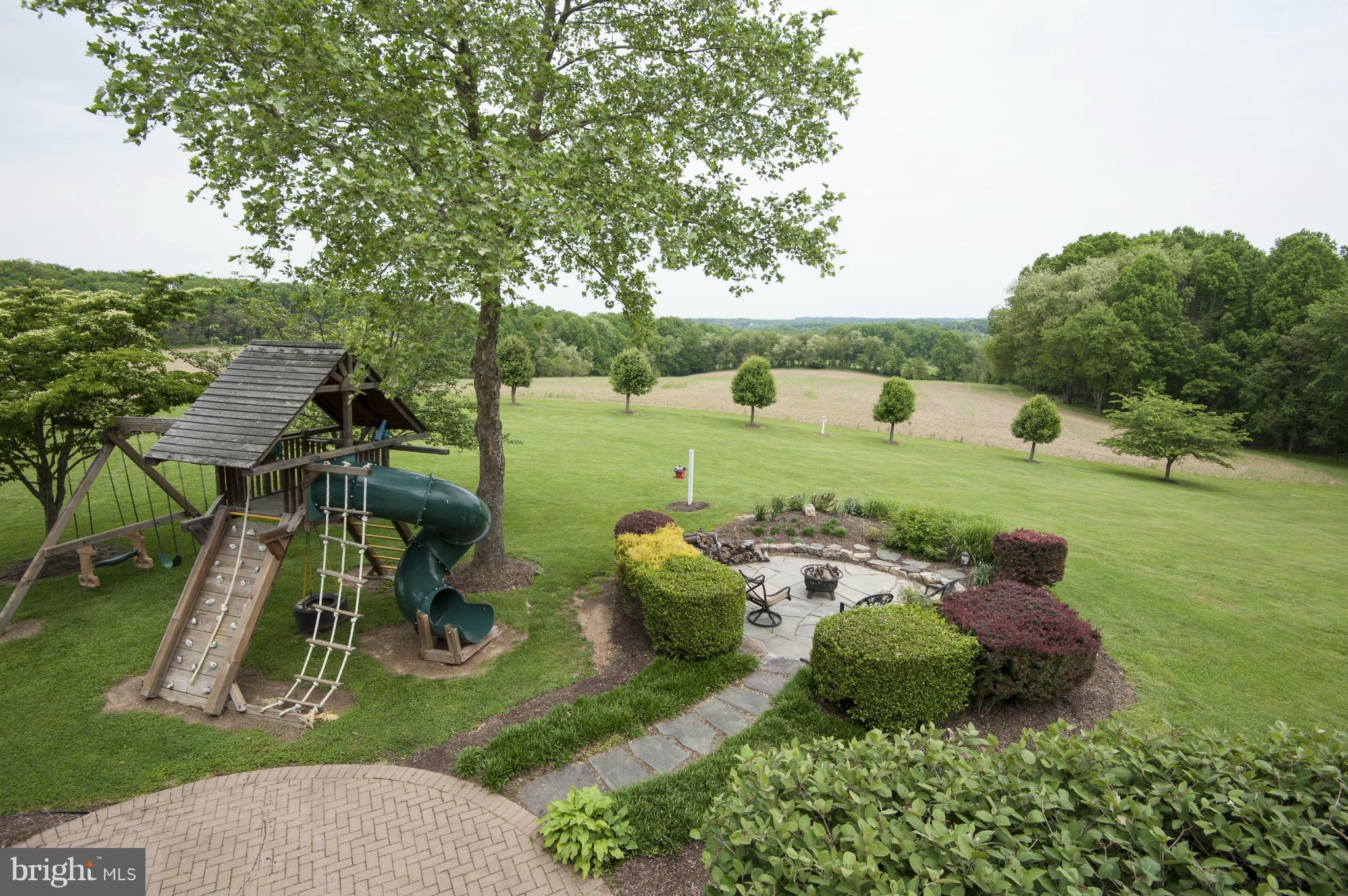 22701 Wildcat Road Germantown, MD 20876 - Photo 22 of 30 Play set, patio, and fire pit