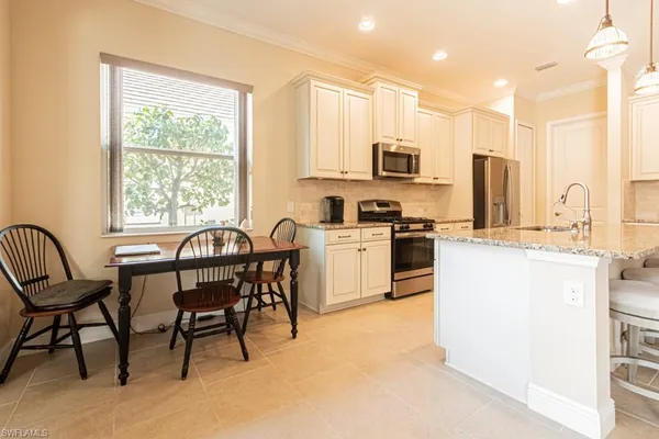 a living room with furniture a flat screen tv and a large window