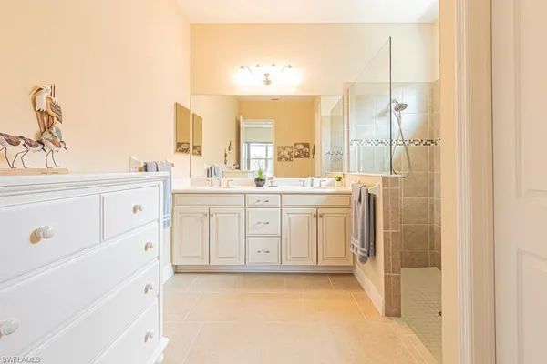 a spacious bedroom with a bed and a couch