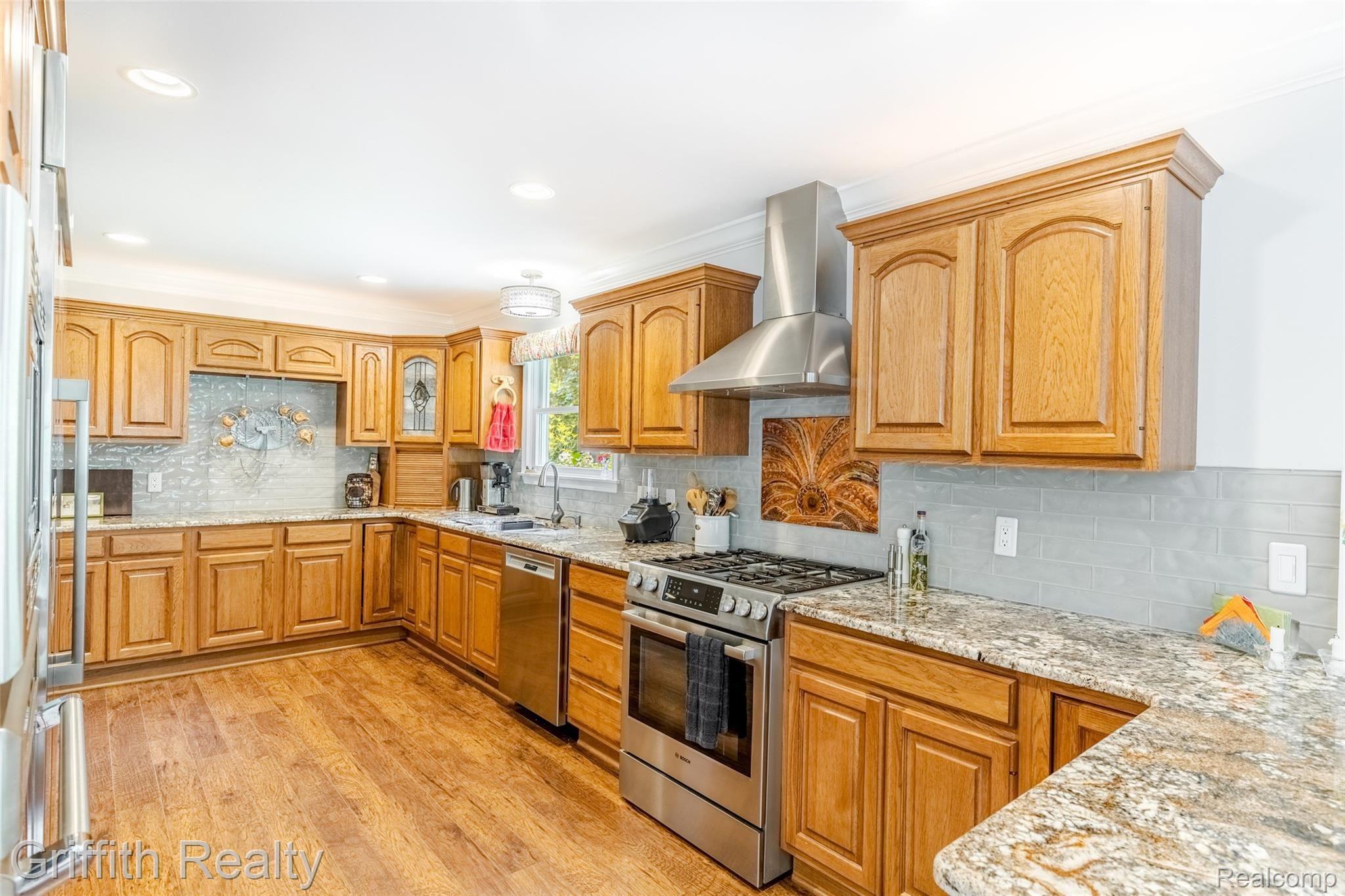2450 Golf Club Road Howell, MI 48843 - Photo 10 of 59 Ample cabinetry carefully planned for an efficient Chef. Note: Bosch dishwasher, appliance garage, granite tops, recessed lighting and more.