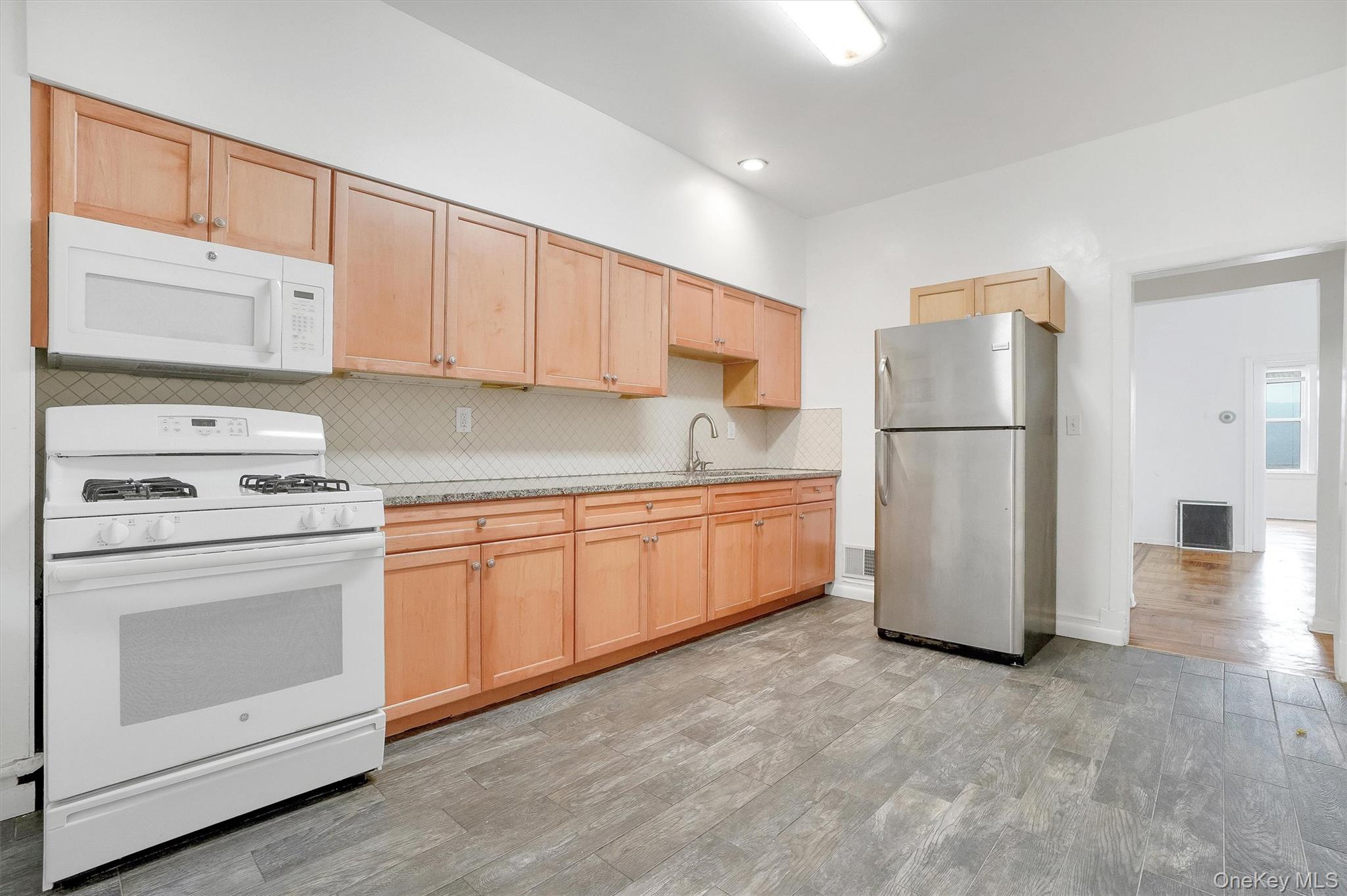 357 Dyckman Street Peekskill, NY 10566 - Photo 15 of 48 a kitchen with a refrigerator sink stove and cabinets