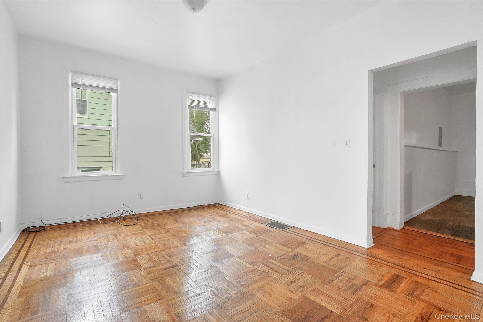 357 Dyckman Street Peekskill, NY 10566 - Photo 19 of 48 a view of an empty room with wooden floor and a window
