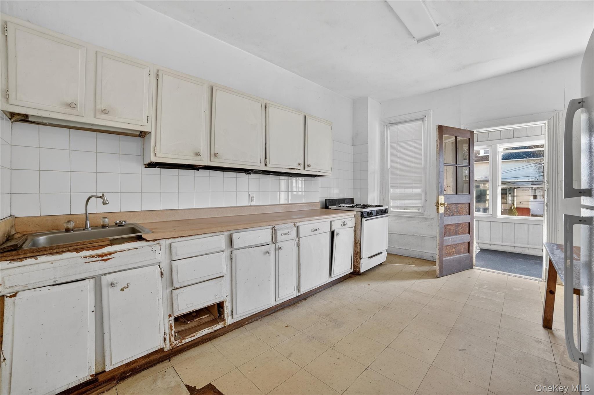 357 Dyckman Street Peekskill, NY 10566 - Photo 29 of 48 a kitchen with granite countertop a sink stove and cabinets