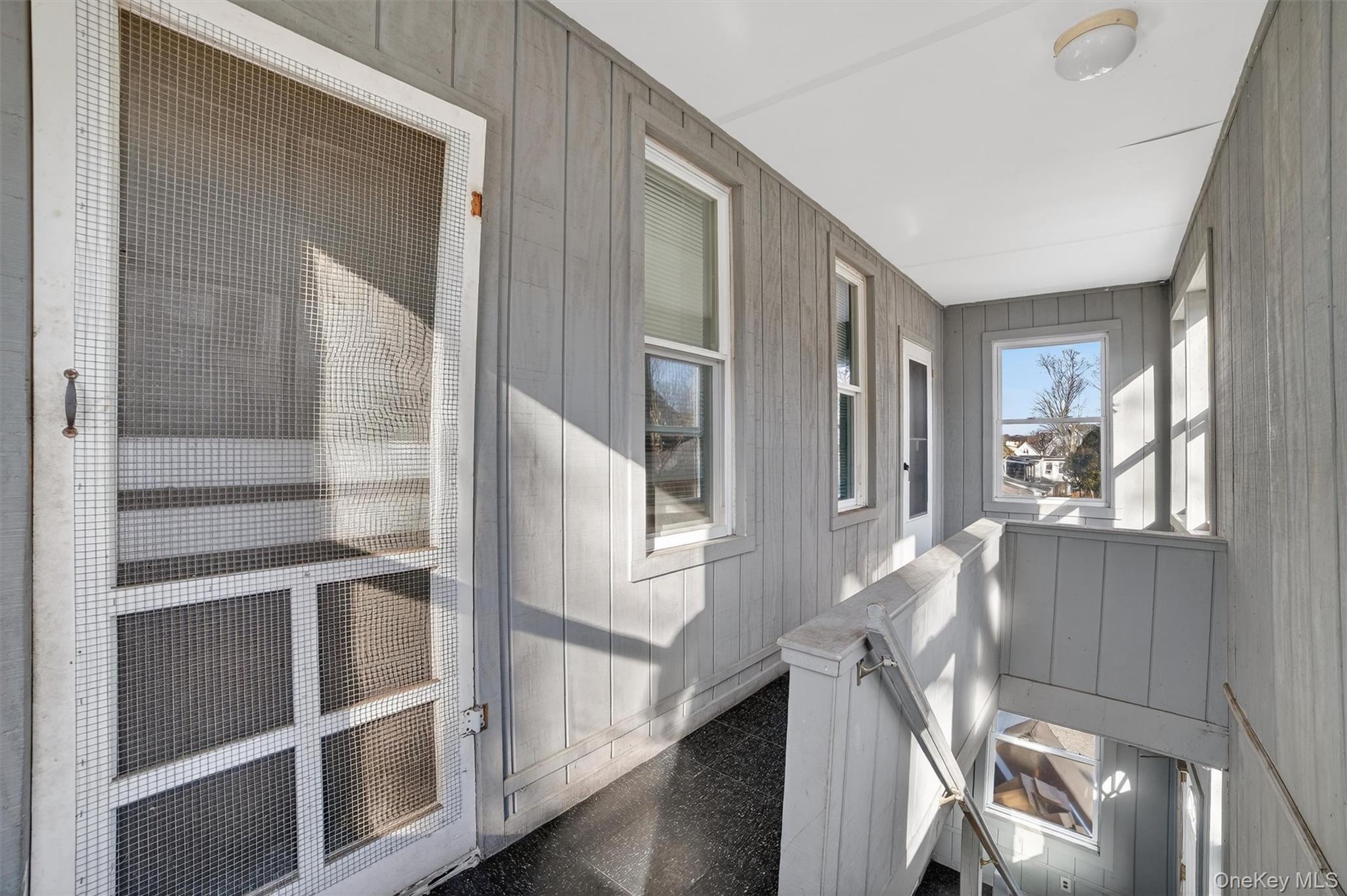 357 Dyckman Street Peekskill, NY 10566 - Photo 30 of 48 a view of staircase with wooden floor and a window