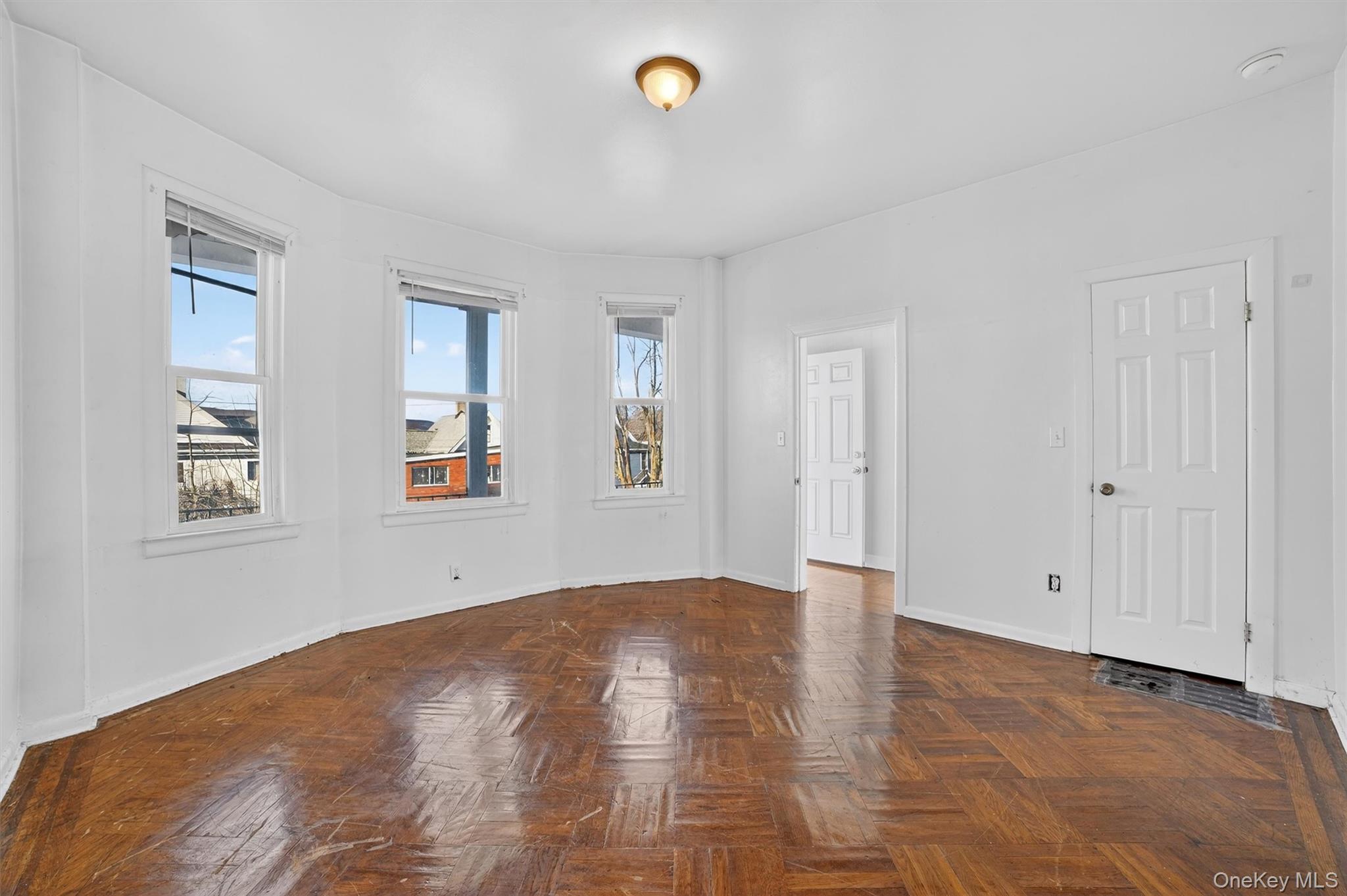 357 Dyckman Street Peekskill, NY 10566 - Photo 31 of 48 wooden floor in an empty room with a window