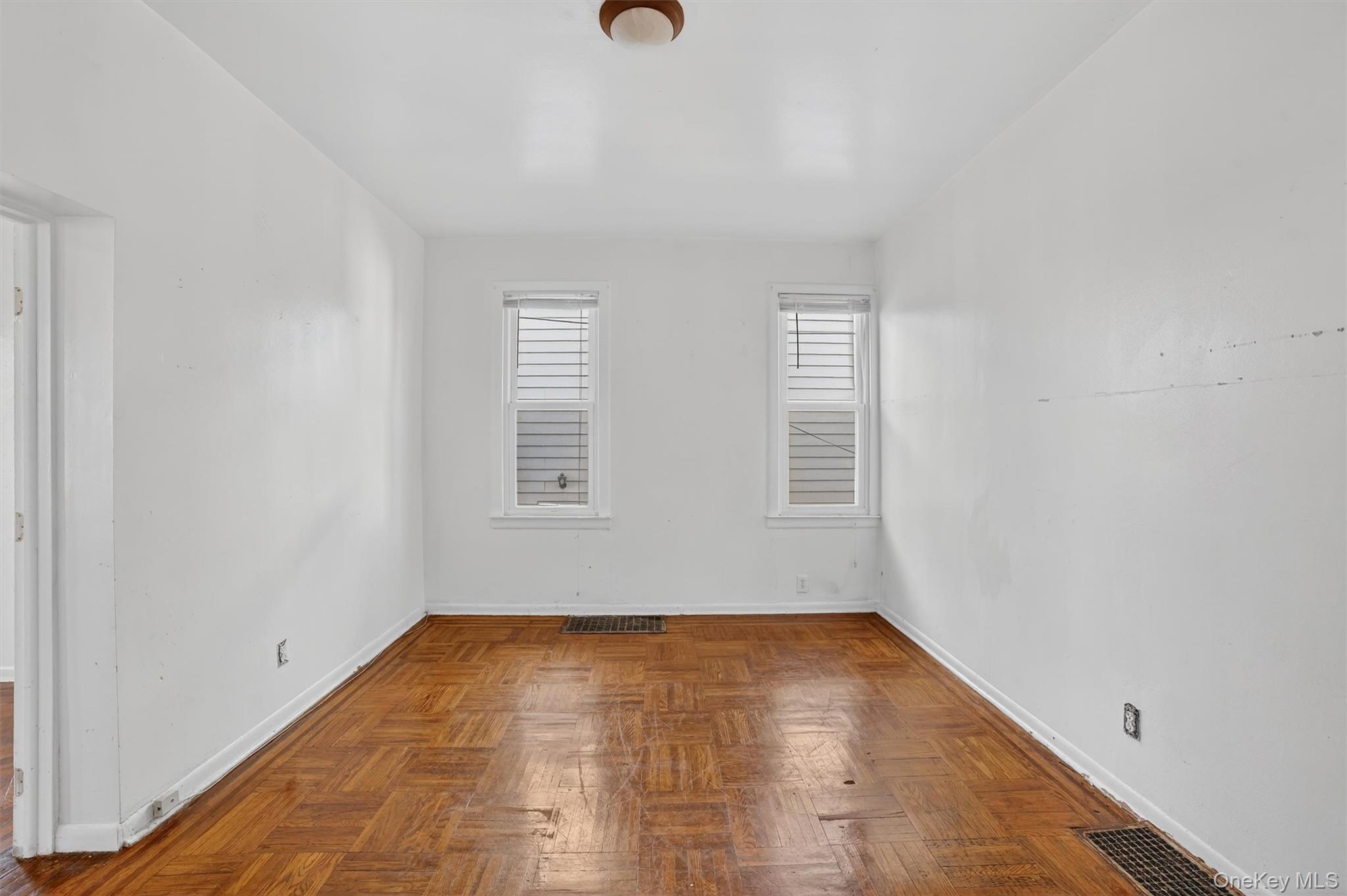 357 Dyckman Street Peekskill, NY 10566 - Photo 36 of 48 an empty room with wooden floor and windows