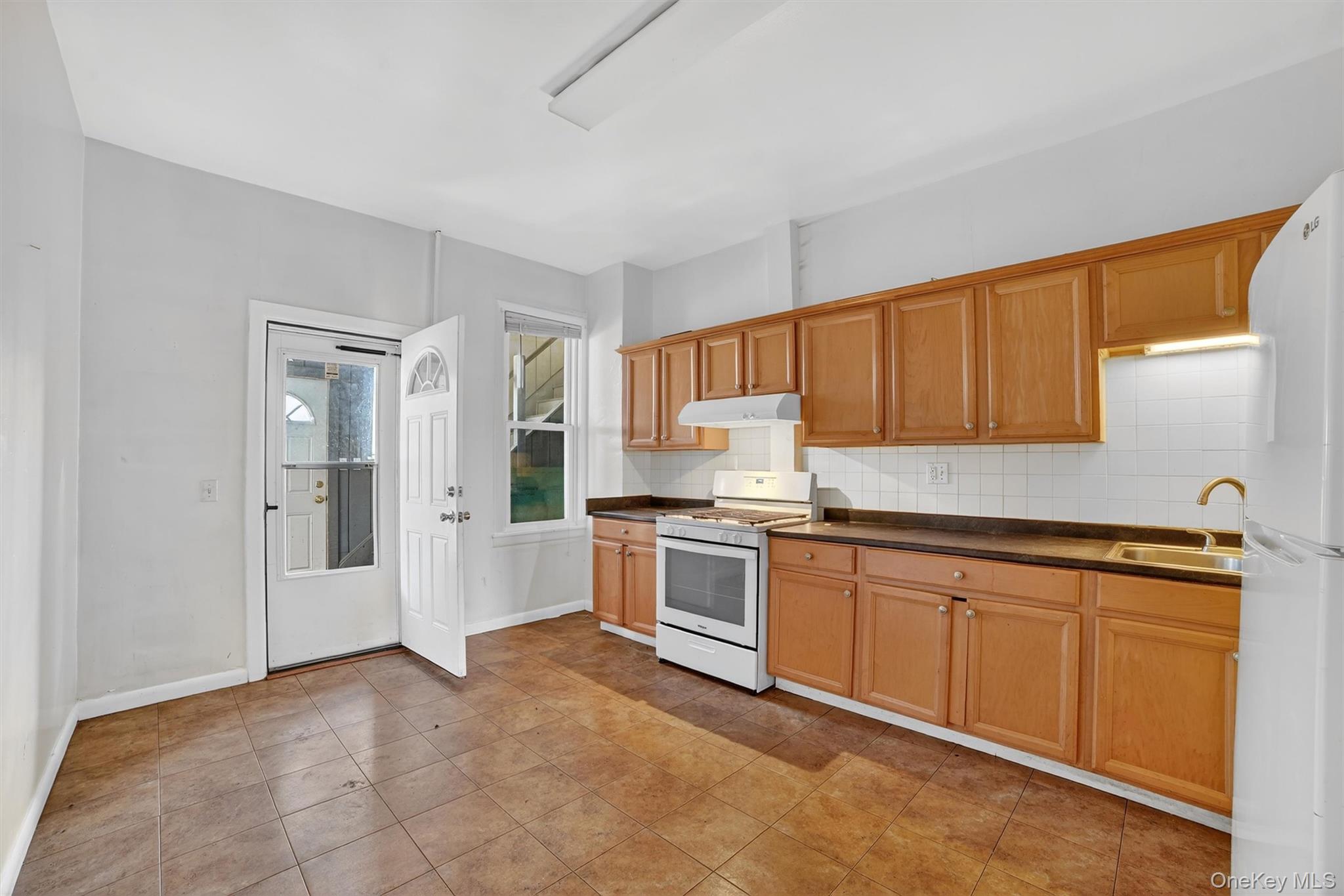 357 Dyckman Street Peekskill, NY 10566 - Photo 38 of 48 a kitchen with stainless steel appliances granite countertop a refrigerator and sink