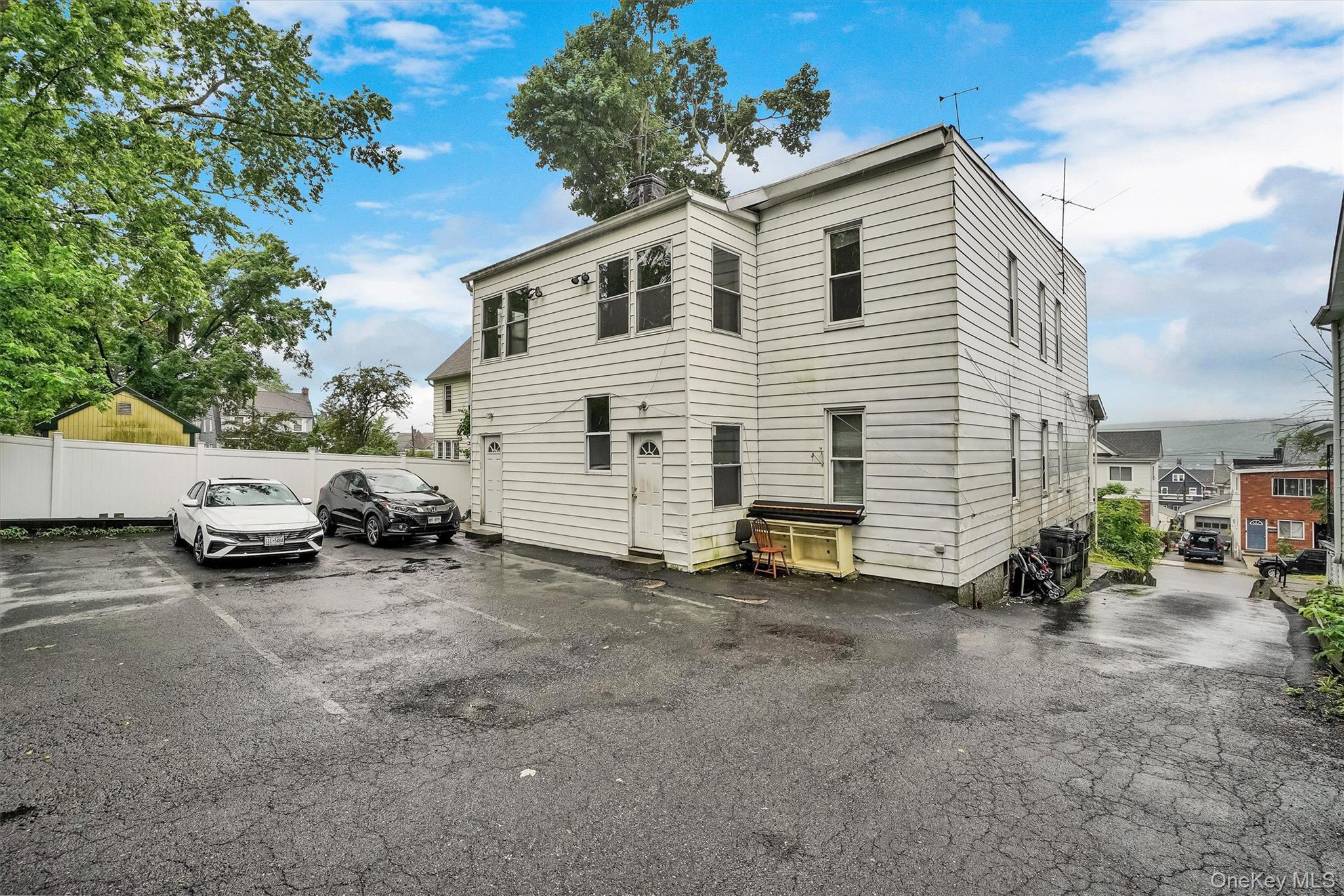 357 Dyckman Street Peekskill, NY 10566 - Photo 40 of 48 a view of a house with a yard and a large tree